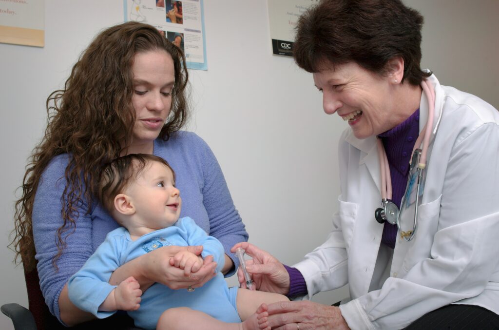 Doctor administers vaccine to a child. Promotional image for Clinical Immunology Update